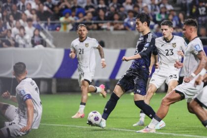 Japan's midfielder Daichi Kamada shoots against Indonesia in Osaka