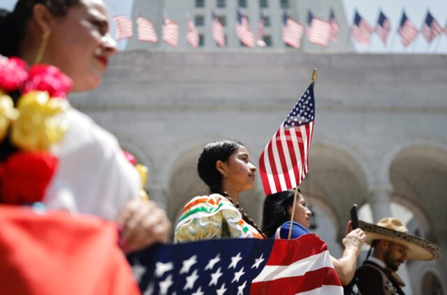 Mariachi and folklorico dancers protest outside Los Angeles City Hall, as protests against