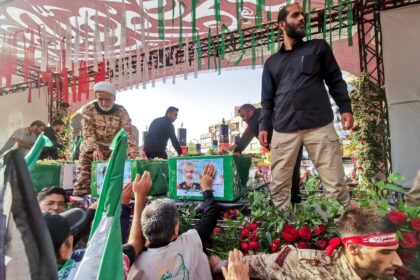 Mourners stand next to the coffin of Iranian Revolutionary Guards commander Hossein Salami