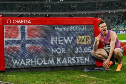 Norway's Karsten Warholm poses with his time of 33.05 seconds after he set a new best in t