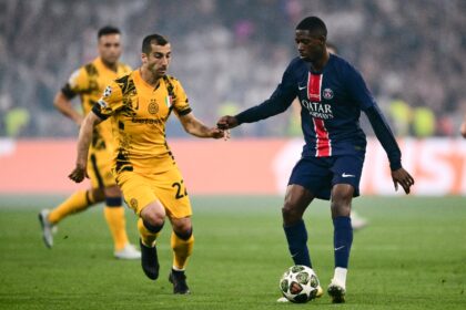 Ousmane Dembele screening the ball from Inter Milan's Henrikh Mkhitaryan