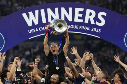 Paris Saint-Germain coach Luis Enrique lifts the Champions League trophy after his side ou