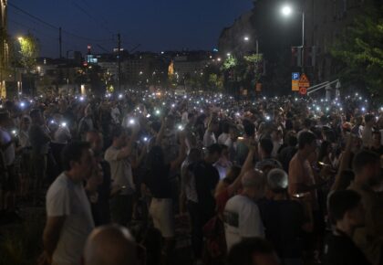 Protesters light up mobile phones as they demonstrate in front of the prosecutors offices