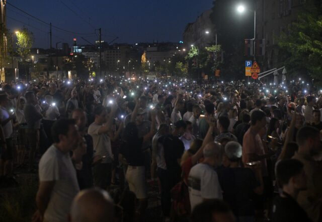 Protesters light up mobile phones as they demonstrate in front of the prosecutors offices