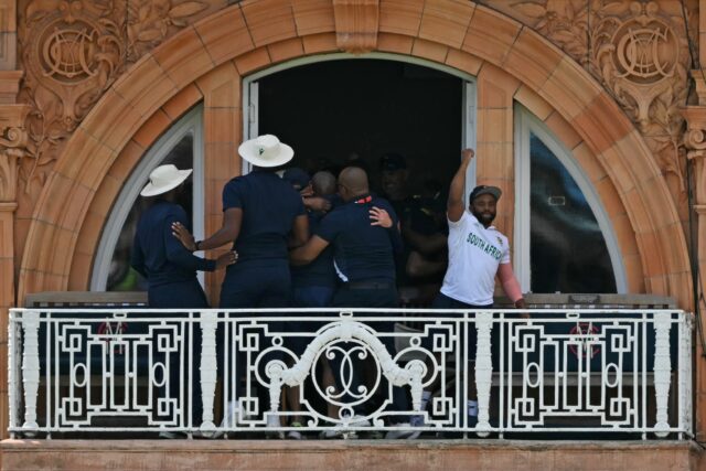 South Africa captain Temba Bavuma (R) celebrates with team-mates on the dressing- room bal
