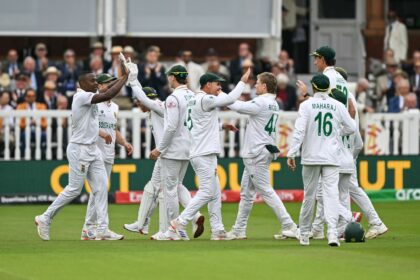 South Africa's Kagiso Rabada (L) celebrates with team-mates after dismissing Australia's C