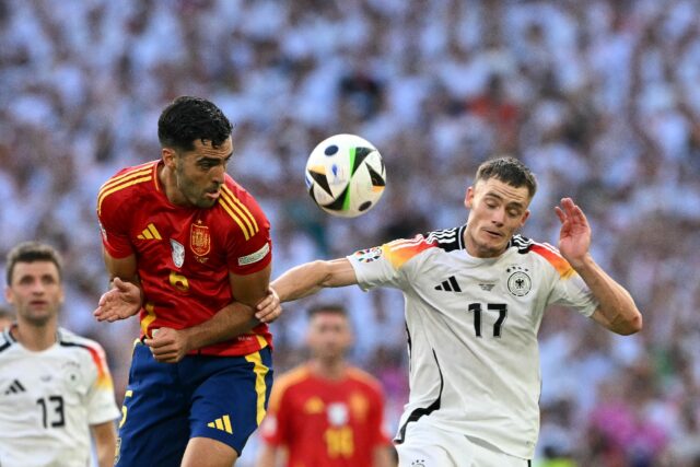 Spain's midfielder Mikel Merino fights for the ball with Germany's midfielder Florian Wirt