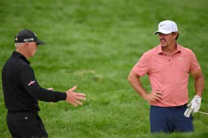 Five-time major winner Brooks Koepka of the United States, right, talks to coach Pete Cowe