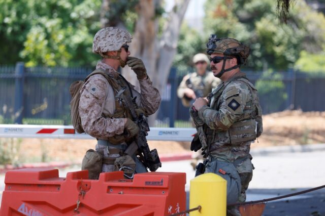 US Marines stand guard at the Wilshire Federal Building in Los Angeles