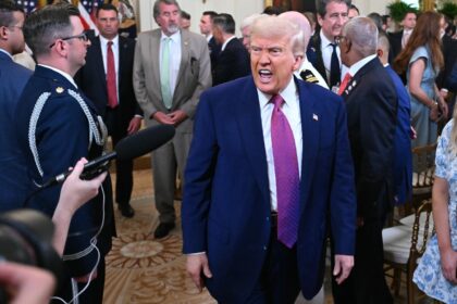 US President Donald Trump departs after signing a bill blocking California's rule banning