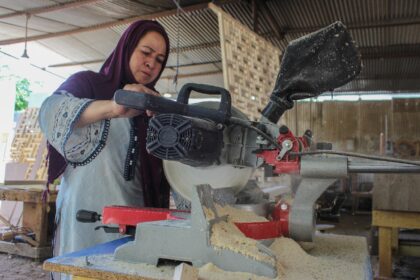 A woman works at a carpentry workshop in Karimabad, in the Hunza district of Pakistan's Gi