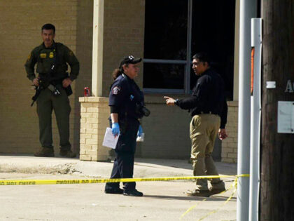 Officials work the scene of a shooting at a Border Patrol facility in McAllen, Texas, Mond