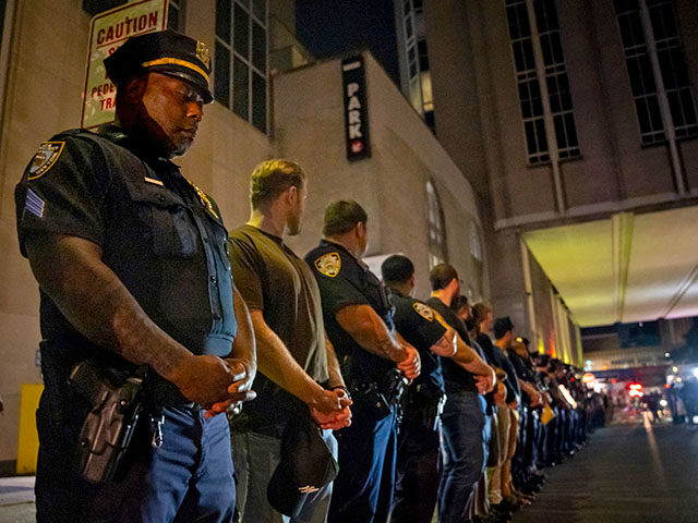 AP25210215513428 Title: Shooting-New York City Image ID: 25210215513428 Article: NYPD officers stand in lin