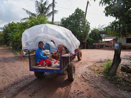 Title: Cambodia Thailand Image ID: 25210220904904 Article: A Cambodian family sits on a tr