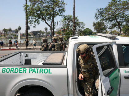 A federal agent with US Customs and Border Patrol (CBP) exits his vehicle near MacArthur P