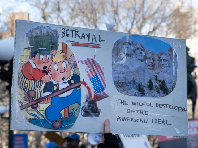 In a large crowd in Union Square on Presidents Day 2025, a homemade collage proclaims &quo