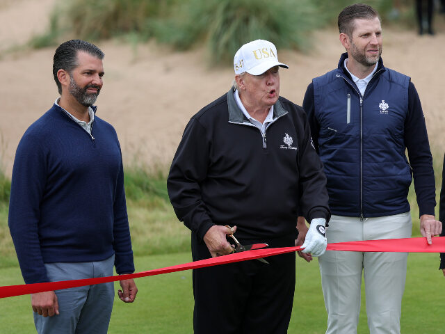 U.S. President Donald Trump cuts the ribbon next to Donald Trump Jr. (L) Eric Trump (2nd R