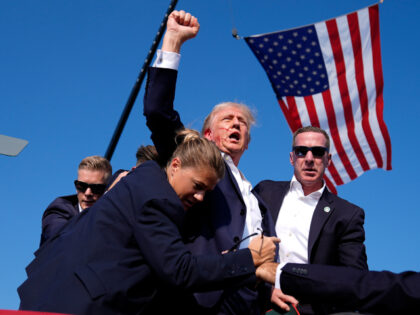 FILE -Republican presidential candidate former President Donald Trump is surrounded by U.S
