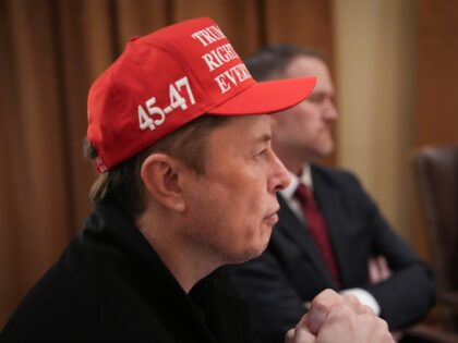 Elon Musk wearing a MAGA hat