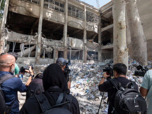 Iranian cameramen capture videos of an office building of the Evin prison, which is destro