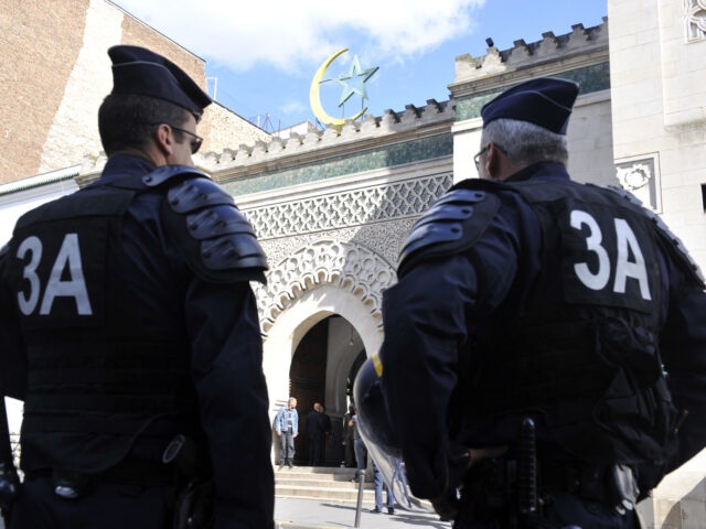 Anti-riot policemen stand in front of the Mosque, on September 22, 2012 in Paris, as polic