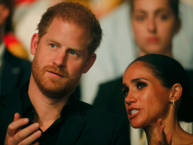 Harry, Duke of Sussex and patron of the Invictus Games (L), and his wife Meghan, Duchess o