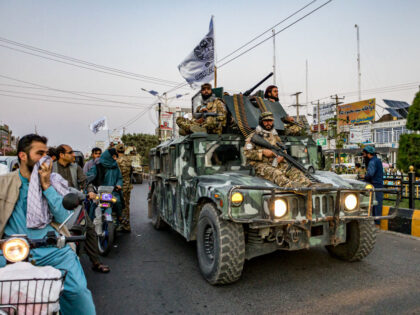 A convoy of Taliban security personnel is seen moving along the streets as they celebrate