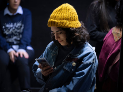 A young Iranian woman uses her smartphone during the Da-Concept Store Fashion and Design e
