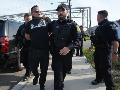 NEWARK, NEW JERSEY - MAY 12: Faith ministers blocked the entrance to the ICE Delaney Hall