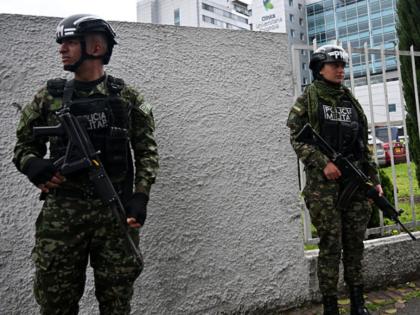Members of the military police stand guard outside the Colombia University Clinic, where t