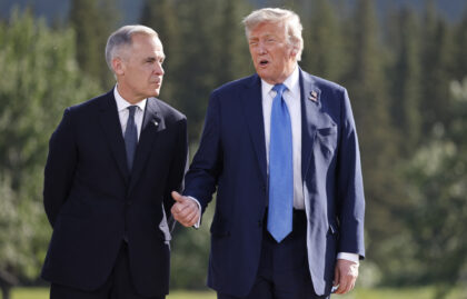 (L-R) Canadian Prime Minister Mark Carney and US President Donald Trump talk during a fami