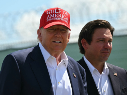 US President President Donald Trump and Florida Governor Ron DeSantis tour a migrant deten