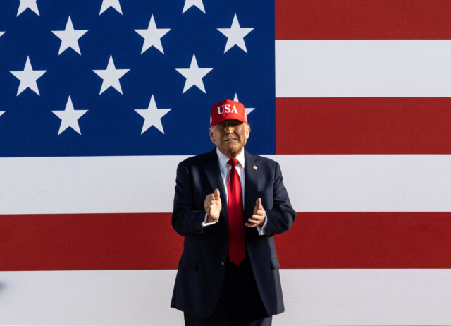 TOPSHOT-US-POLITICS TOPSHOT - US President Donald Trump claps as he arrives to speak at the Salute to America