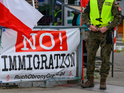 07 July 2025, Poland, Slubice: A Polish military policeman stands next to a banner reading
