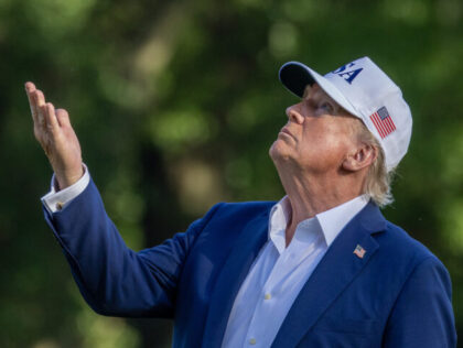 WASHINGTON, DC - JULY 06: U.S. President Donald Trump looks up at the new flag on the sout