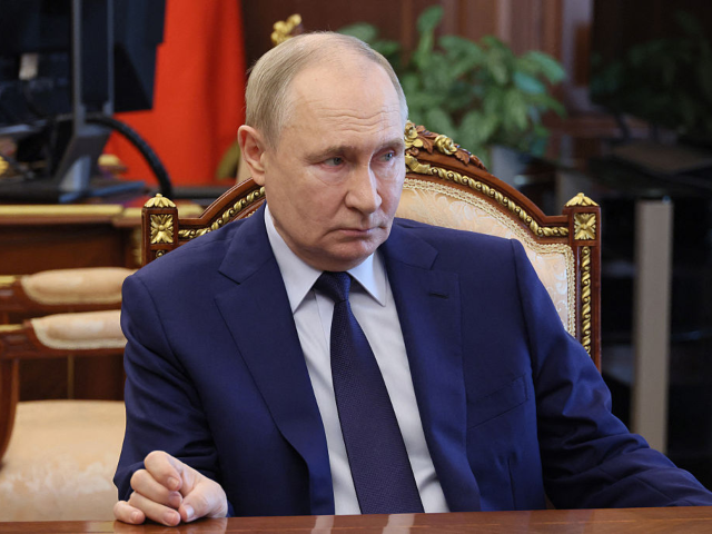 In this pool photograph distributed by Russian state agency Sputnik, Russia's President Vl