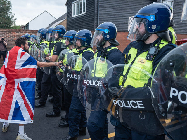 LONDON, UNITED KINGDOM - 2025/07/17: A far-right anti-immigration protester taunts a cordo
