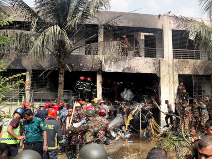Bangladesh's fire service and security personnel conduct a search and rescue operatio