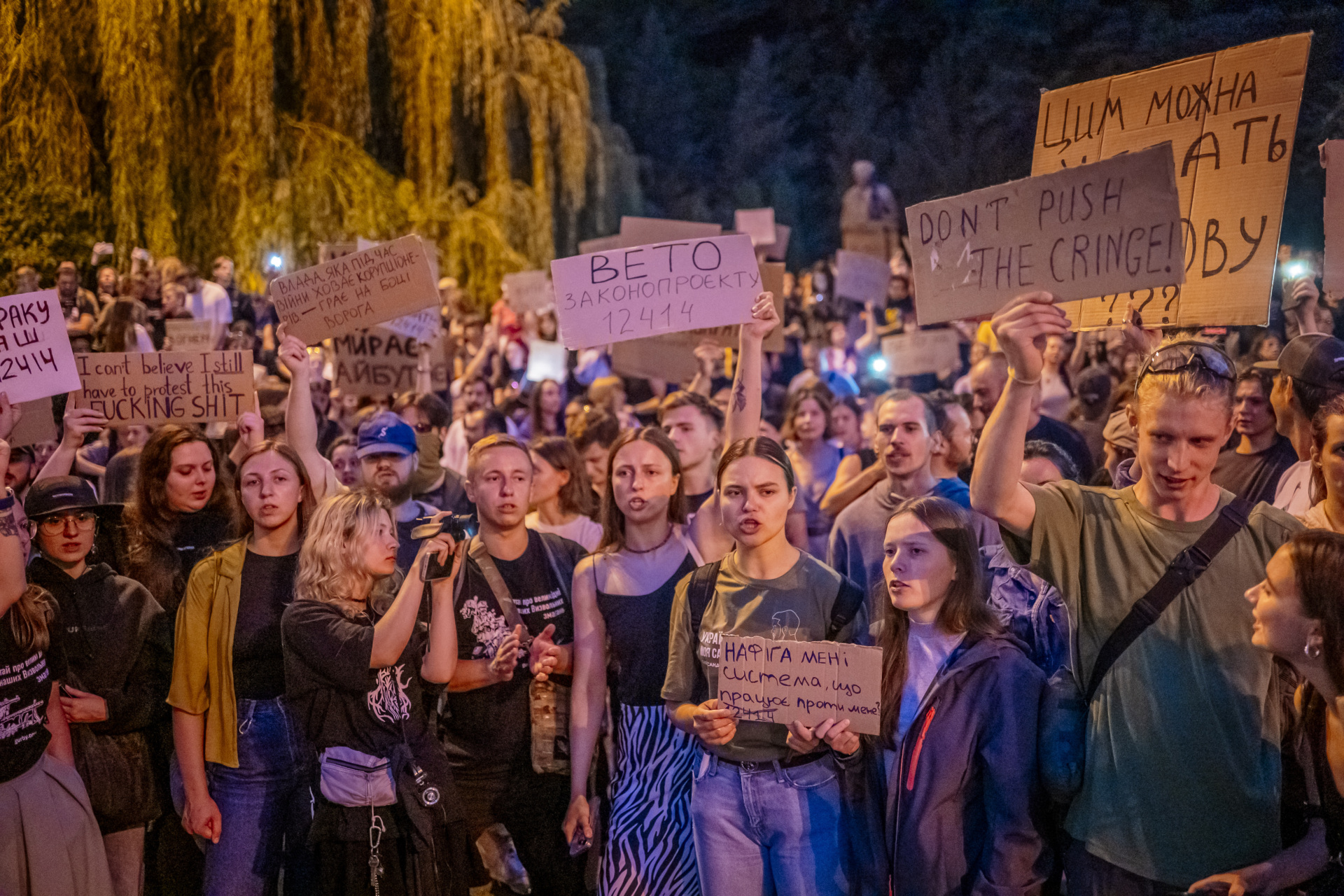 KYIV, UKRAINE - JULY 22: Protesters hold placards during rally against law that restricts independence of anti‑corruption institutions on July 22, 2025 in Kyiv, Ukraine. In city centre in the garden square not far from the Presidential Administration, people gathered despite martial law to protest a bill passed stripping independence of National Anti-Corruption Bureau and Specialized Anti-Corruption Prosecutor's Office. Demonstrators chanted and carried banners demanding protection for Ukraine’s anti‑corruption institutions. (Photo by Dan Bashakov/Global Images Ukraine via Getty Images)