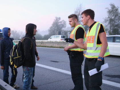 NEUHAUS AM INN, GERMANY - AUGUST 30: Police speak to a group of Afghan migrants who had cr