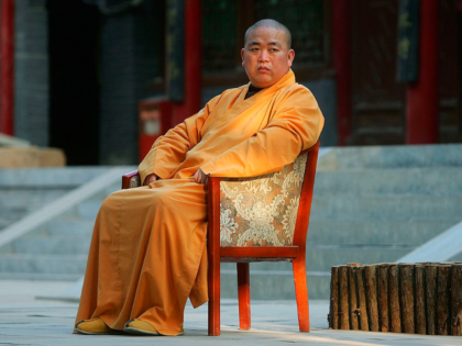 DENGFENG, CHINA - APRIL 6: Shi Yongxin, abbot of the Shaolin Temple, takes a break after b