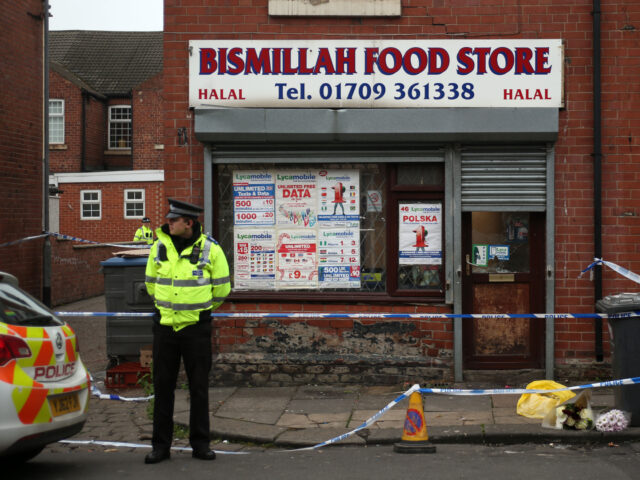 Police outside a shop in Grosvenor Road, Rotherham where Parvaiz Iqbal was killed. (Photo