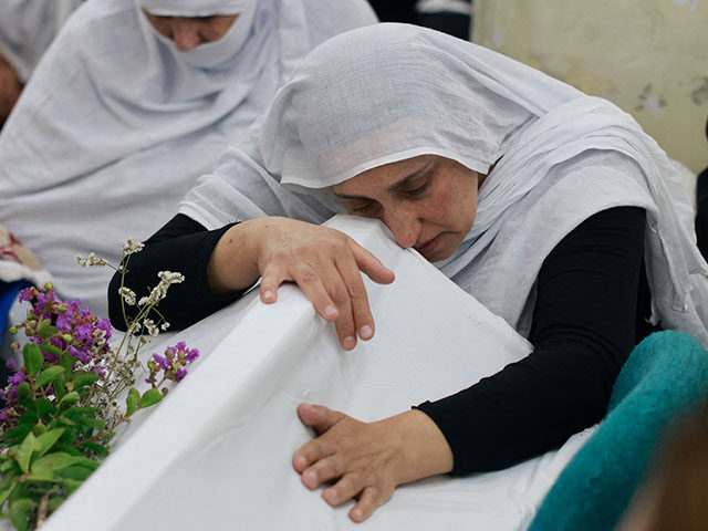 Druze women mourn near the coffin of a loved one after a reported strike from Lebanon fell