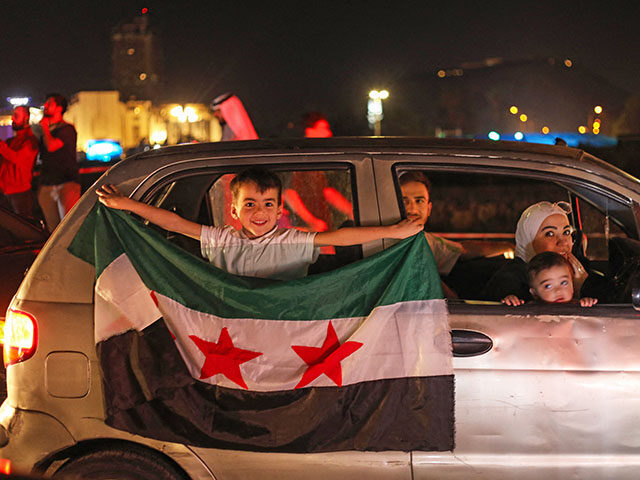 People celebrate in Damascus' Omeyyad square after US President Donald Trump's decision to