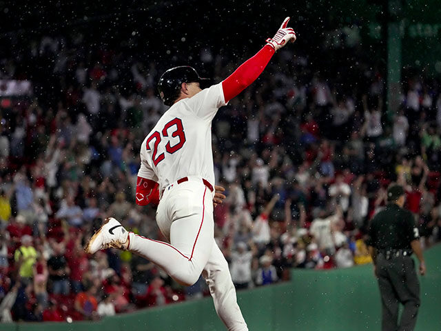 Boston Red Sox second baseman Romy Gonzalez points skyward as he runs the bases after hitt