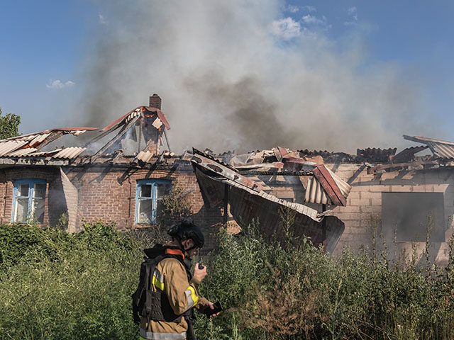 Ukrainian emergency service workers extinguish a fire of unknown origin in a house 7km fro