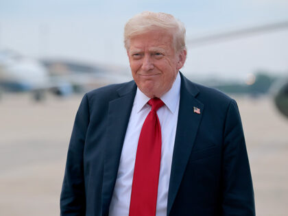 U.S. President Donald Trump talks to reporters after returning to Washington after attendi