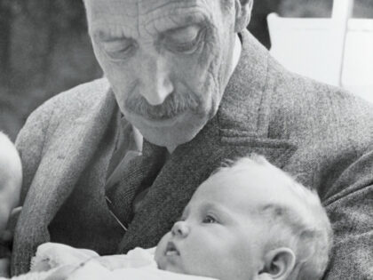 Newborn Princess Margrethe as a baby, is shown in the arms of her grandfather, the late Ki