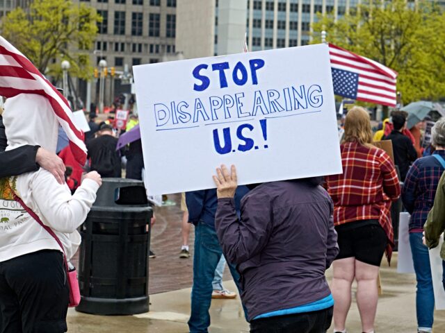 People affiliated with the 50501 movement gather at Hart Plaza in downtown Detroit, Michig