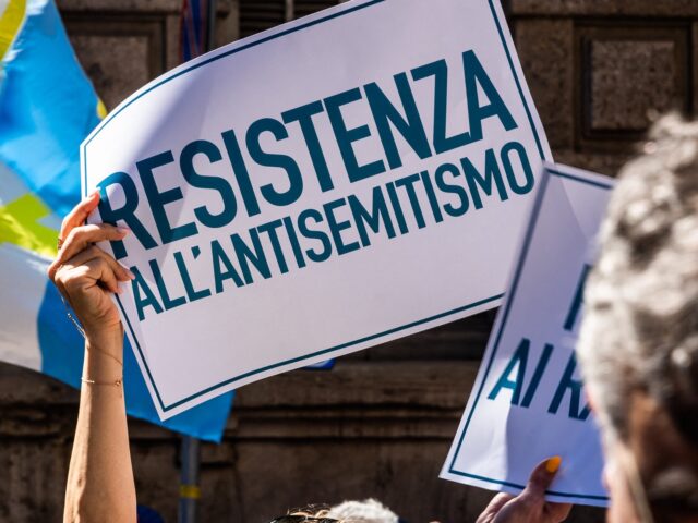 Woman with sign of resistance against antisemitism in the group of the Jewish brigade or b